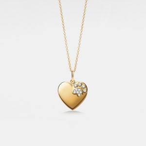 May include: A gold heart-shaped pendant necklace with a diamond paw print design.