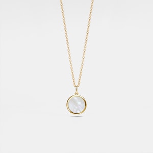 May include: A gold chain necklace with a round white mother-of-pearl pendant.