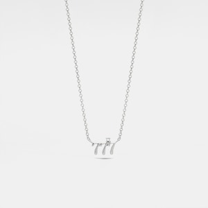 May include: A silver necklace with a pendant that says "777" with a small diamond in the center.