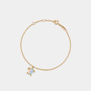 May include: A gold chain bracelet with a small opal turtle charm. The turtle is a popular symbol of good luck and longevity.
