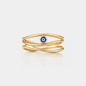 May include: A gold ring featuring a blue and white evil eye charm. The ring is crafted from three interwoven bands.