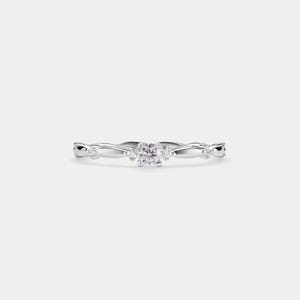 May include: A delicate silver ring with a small, round, clear gemstone in the centre and smaller gemstones on either side.