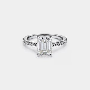 May include: A silver engagement ring with a large, clear emerald-cut diamond and a band of smaller diamonds.