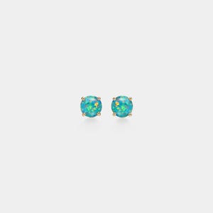 May include: A pair of stud earrings featuring round, iridescent blue-green opal stones set in gold-colored prongs. The earrings are displayed against a plain white background, highlighting their vibrant color and design.