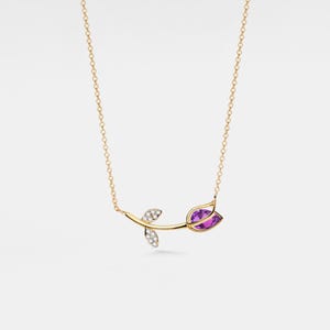 May include: A gold necklace with a delicate rose pendant featuring a purple gemstone and diamond accents.