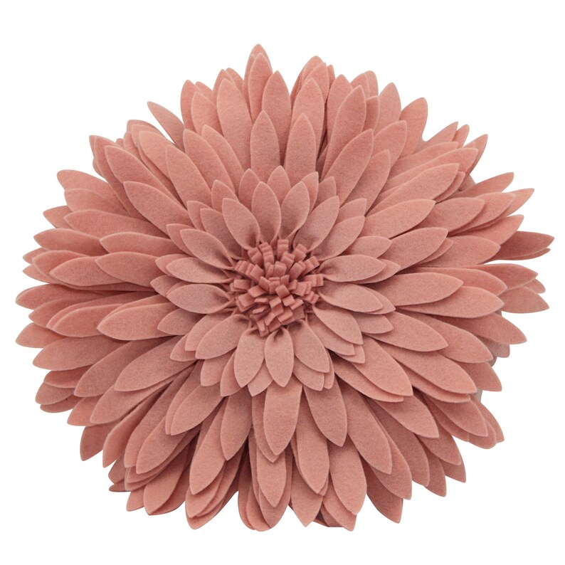 May include: A round, dusty rose-colored decorative pillow shaped like a large flower. The pillow features layered, petal-like felt pieces radiating from the center, creating a three-dimensional floral design. The pillow is a soft, muted pink.