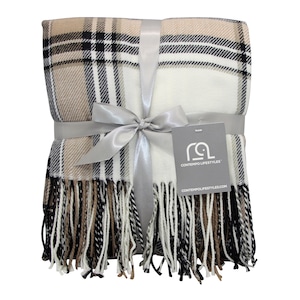 May include: A beige, black, and white plaid throw blanket with fringe. The blanket is tied with a silver ribbon and bow. The tag on the blanket reads "CONTEMPO LIFESTYLES" and "CONTEMPLOLIFESTYLES.COM".