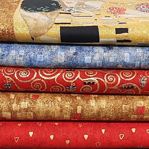 May include: A selection of fabric rolls with diverse patterns. The top roll showcases a portion of Gustav Klimt's "The Kiss". Other rolls display blue, red, and gold designs, including swirls, squares, and geometric shapes. These fabrics are suitable for crafting or home decor projects.