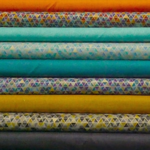 May include: A stack of fabric featuring a variety of geometric patterns in shades of orange, teal, blue, and yellow.