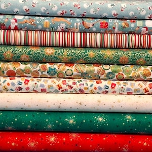 May include: A stack of nine fabric bolts featuring various holiday patterns including snowmen, Santa Claus, woodland animals, vertical stripes, ornate green swirls, Christmas ornaments, colourful gift boxes, and gold stars on white, green, and red backgrounds.