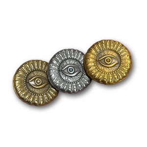 May include: Three metallic, circular pendants with an eye design. The pendants are in gold, silver, and bronze tones. Each pendant features an eye in the center, surrounded by an engraved border of symbols.