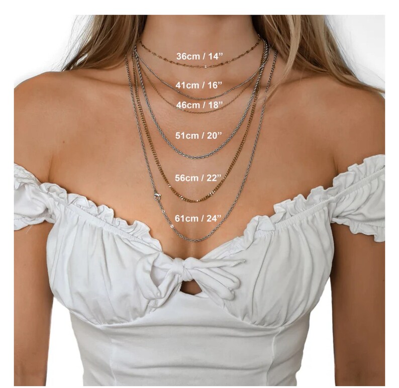 May include: A model wears a variety of silver and gold chain necklaces, each with a different length. The lengths are labeled in inches and centimeters: 14 inches/36 cm, 16 inches/41 cm, 18 inches/46 cm, 20 inches/51 cm, 22 inches/56 cm, and 24 inches/61 cm.