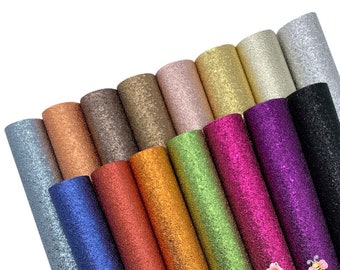 May include: A collection of 15 rolls of glitter faux leather in various colors, including silver, gold, copper, green, blue, purple, and black. The faux leather has a textured, sparkly finish.