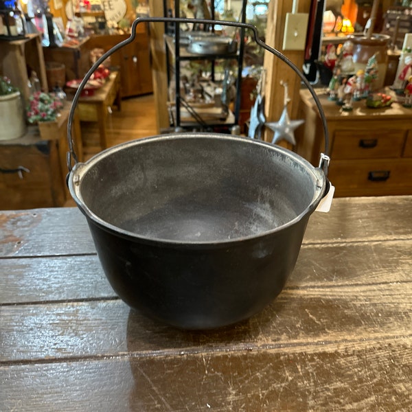 Antique cast iron kettle with steel handle