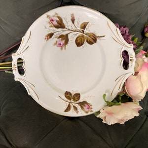 Lovely vintage handled cake plate, pink roses with stems, handles have gold design, cut out