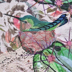 May include: A detailed textile art piece featuring a hummingbird perched on a nest. The bird has green and blue feathers, a long black beak, and is set against a backdrop of floral and geometric patterns in pink, green, and brown.