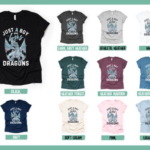 May include: A collection of t-shirts in various colors featuring a graphic of a blue dragon with the text "Just a boy who loves dragons".