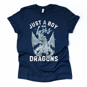 May include: Navy blue t-shirt with a white graphic of a dragon and the text "Just a boy who loves dragons".