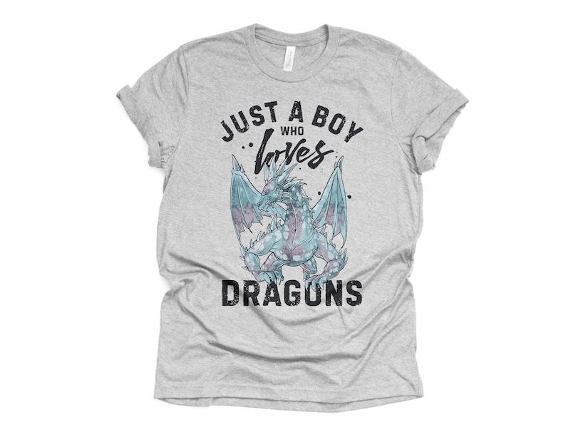 May include: A gray t-shirt with the text "Just a boy who loves dragons" in black. A blue dragon with wings is in the center of the text.