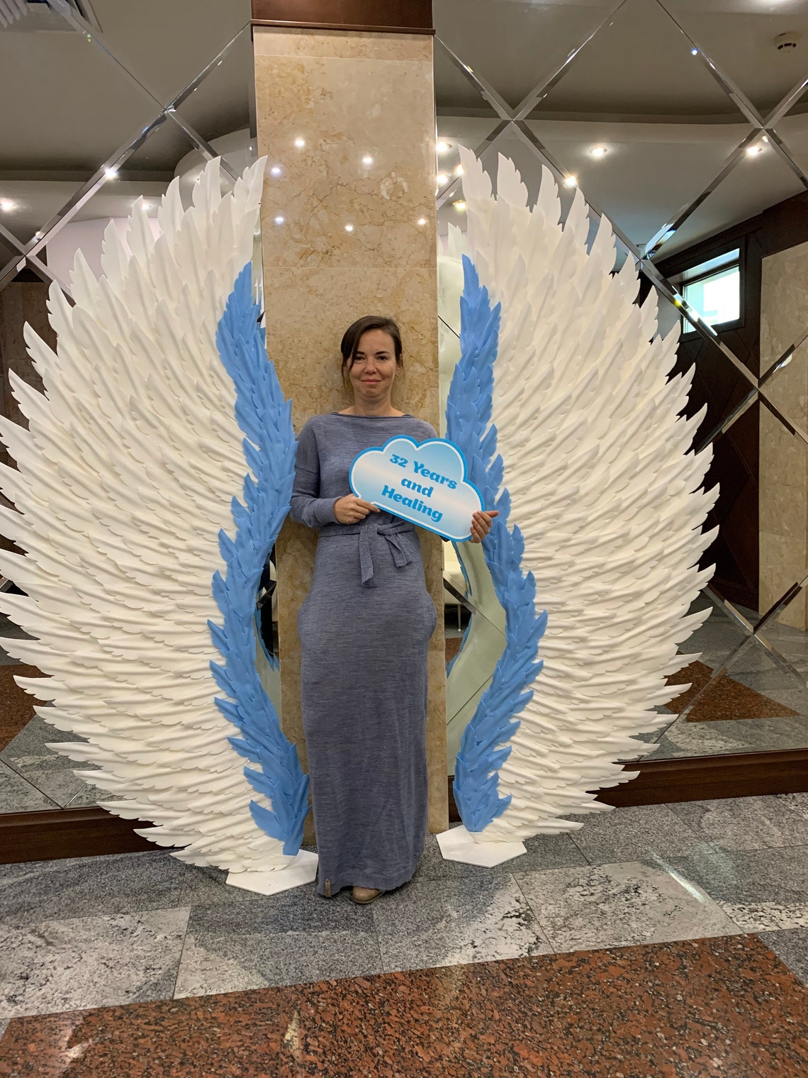 Two giant angel wings on metal stands including Express Etsy