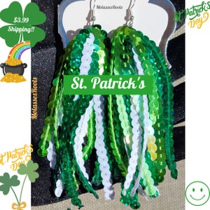 May include: Green and white sequin dangle earrings with a St. Patrick's Day theme.