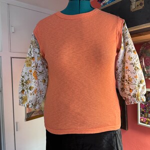 Upcycled Orange Tank w/added puff sleeves! Sheeting used for puff sleeves! Knit stretch fabric tank gives alot of stretch to this top!