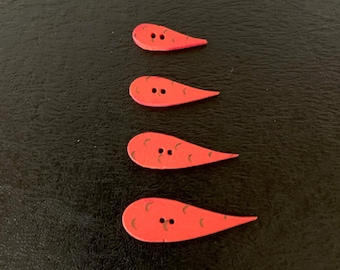 May include: Four red teardrop-shaped buttons with black stitching and a pattern of black lines.