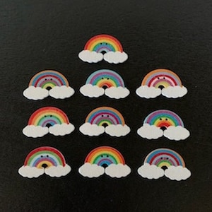 May include: Twelve rainbow-colored wooden buttons with a cloud shape and a smiling face. Each button has a different color rainbow.