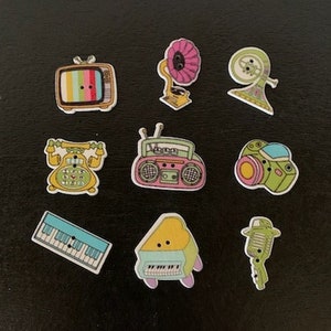 May include: Nine colorful wooden buttons with various retro-themed designs, including a television, a phone, a record player, a microphone, a car, and a piano.