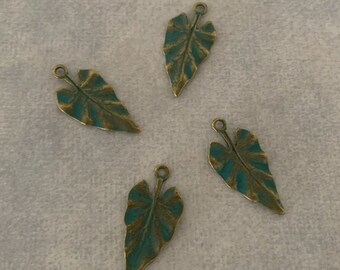 May include: Four antique bronze leaf charms with a teal green patina. The leaves are shaped like a heart and have a detailed vein pattern.