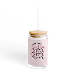 May include: A pink glass tumbler with a bamboo lid and a clear straw. The tumbler has a gold square frame around the text "I'm Working On Myself For Myself By Myself" with two small hearts above the first "Myself".