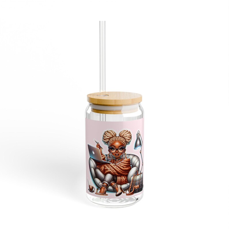 May include: A clear glass tumbler with a bamboo lid and a straw. The tumbler features a colorful illustration of a woman with braids sitting in a chair with a laptop and a lamp.