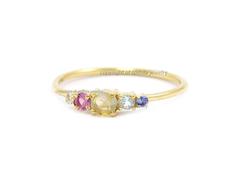 14k gouden ring met meerdere edelstenen: opaal, topaas, saffier, robijn, diamant