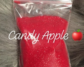 May include: A small clear plastic bag filled with red glitter. The bag is labeled "Candy Apple".