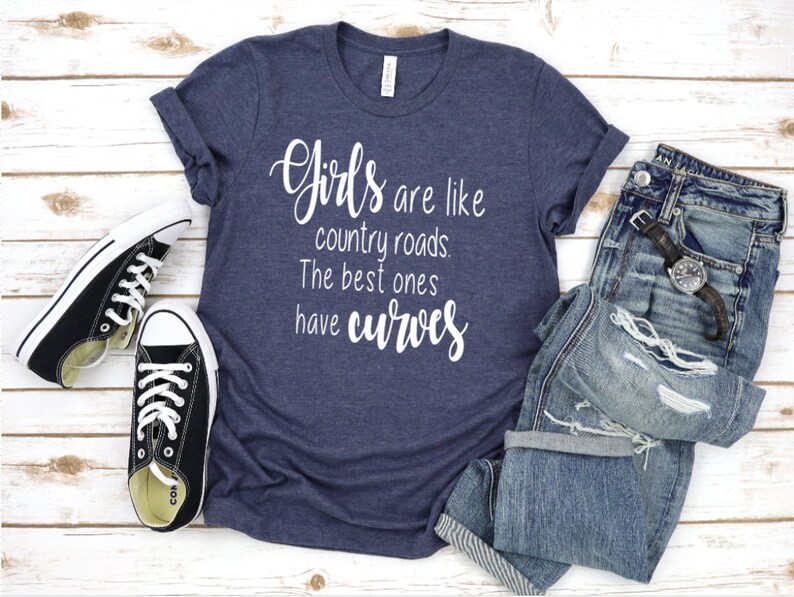 May include: A navy blue t-shirt with the text "Girls are like country roads. The best ones have curves" in white lettering.