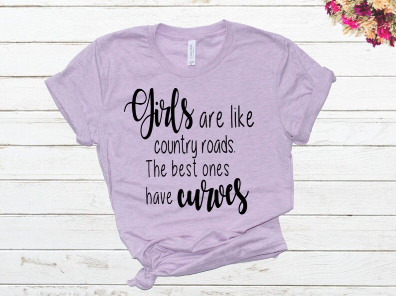 May include: A light purple t-shirt with the text "Girls are like country roads. The best ones have curves" printed in black.