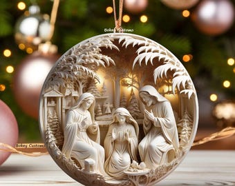 May include: A cream-colored Christmas ornament featuring a detailed relief scene of the Nativity. The ornament depicts Mary, Joseph, and baby Jesus in a circular frame with a forest backdrop. The ornament is hanging with a gold string.