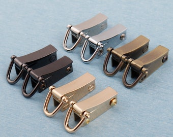 May include: Six pairs of metal swivel clasps in different finishes: black, silver, gold, and brass. Each clasp has two D-rings.