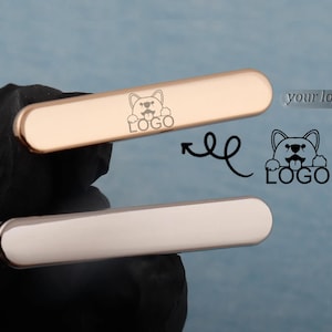 May include: Two metallic bars, one gold and one silver, are shown. Each bar has rounded edges and a dog logo. The gold bar is positioned above the silver bar. The dog logo is also shown as a separate graphic with the text "LOGO".