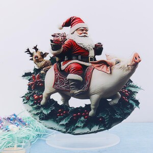 May include: A whimsical Christmas decoration featuring Santa Claus riding a pig, with a reindeer and holly. Santa wears a red suit and hat, holding gifts. The pig is white with pink ears and snout. The decoration is on a clear stand.
