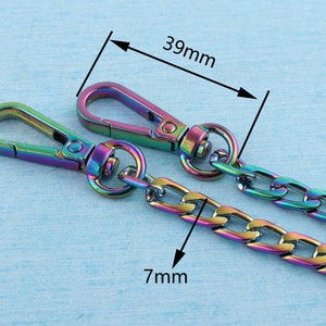 May include: A rainbow-colored metal chain with two lobster clasps. The chain is 7 mm wide and 39 mm long.
