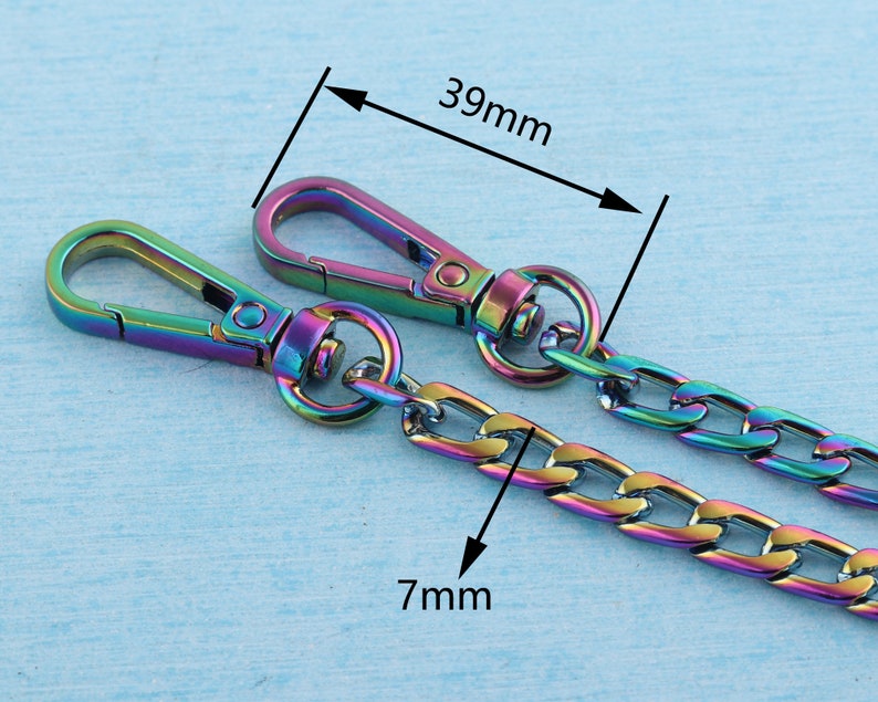 May include: A rainbow-colored metal chain with two lobster clasps. The chain is 7 mm wide and 39 mm long.