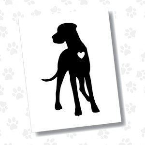 May include: A black silhouette of a dog with a white heart on its side. The dog is standing, facing left, with its tail curved. The image is on a white background with paw prints.