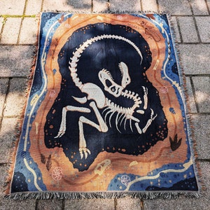 The King's Grave Dinosaur Fossil Woven Blanket