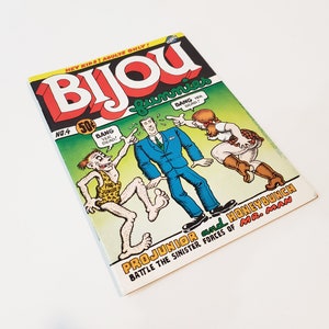 May include: A vintage comic book titled "Bijou" with a colourful cover. The cover features cartoon illustrations of characters in action, with speech bubbles saying "Bang". The comic is marked "No. 4" and priced at 50 cents.