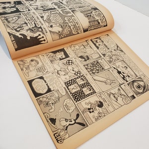 May include: Open comic book pages with black and white illustrations. The comic features various panels with detailed drawings and speech bubbles. The text "THE END" is visible. The pages have a vintage, aged appearance.