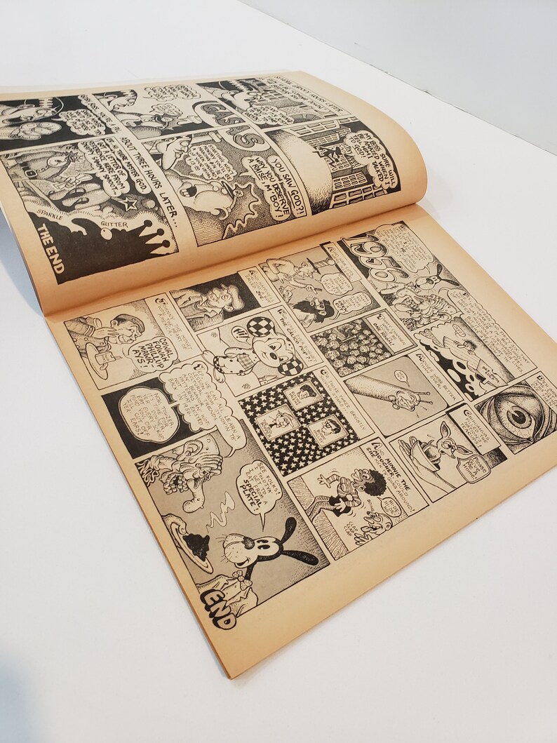 May include: Open comic book pages with black and white illustrations. The comic features various panels with detailed drawings and speech bubbles. The text "THE END" is visible. The pages have a vintage, aged appearance.