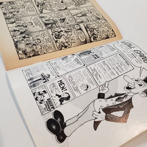 May include: A vintage comic book open to two pages of black and white illustrations. The top page shows a comic strip with speech bubbles. The bottom page has a cartoon man and advertisements. Text includes "Wow Gang" and "Men!"