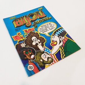 May include: A vintage comic book titled "Bijou Funnies" with a blue background and colorful illustrations of cartoon characters. The cover includes text that reads "Adults Only!" and a speech bubble.