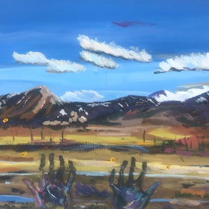 May include: A painting of a landscape with mountains in the background and two hands reaching up from the foreground. The sky is blue with white clouds. The mountains are brown and purple with snow on the peaks. The hands are painted in a dark purple color.